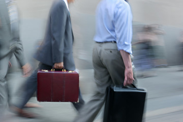motion blurred business people walking on the street