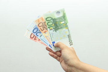 female hand holding a range of euro banknotes