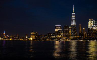 Fototapeta na wymiar downtown and midtown Manhattan against dark blue sky