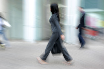 Fototapeta premium motion blurred business people walking on the street