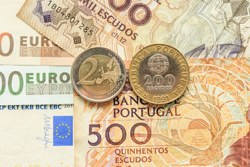 euro notes and coins and Portuguese escudo