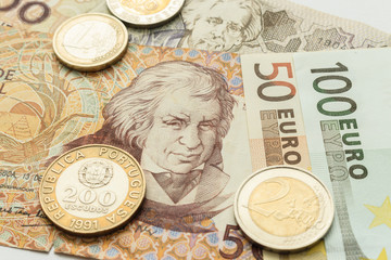 euro notes and coins and Portuguese escudo