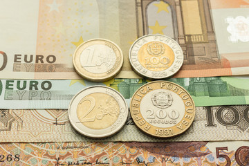 euro notes and coins and Portuguese escudo