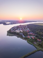 Beautiful sunset over estuary of Vistula river in Gdansk. Summer sunset over sea and river and small village.