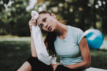 Woman in Sportswear after Yoga Exercises in Park.