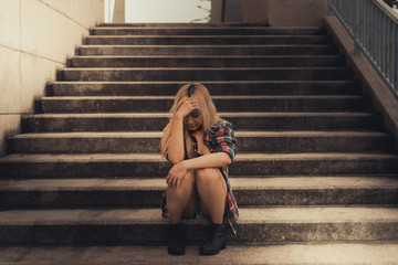 Lonely asian woman sit alone in the park,Sad thai woman think something,Heartbreak girl concept