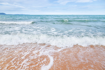 white soft wave rolling splash on empty tropical sandy beach in sunny day