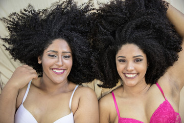 Two young afro girls having fun together, joy, positive, love, friendship, sisters.