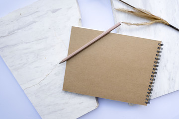 Notebooks, pencils and pencils are placed with a white background with white stones , top view , flat lay