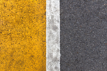 Background of yellow black strips . Dark grey asphalt road divided by yellow paint. yellow black background. using for book cover or your design..