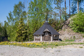 A fairy-tale house in the glade of dandelions in Ruskeala