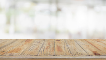 Empty wood table top and blurred restaurant interior background - can used for display or montage your products.