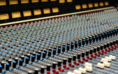 A closeup of a large mixing console.