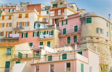 Fototapeta na wymiar Brightly colored tiered apartments typical of coastal Italian villages