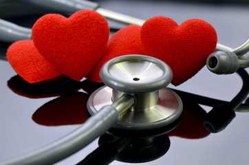 Heart and stethoscope on dark background in healthy heart concept.