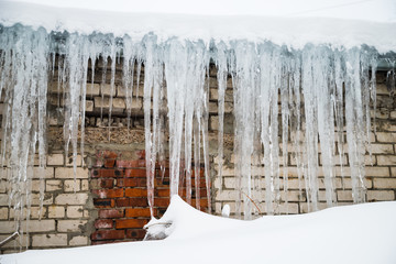 Icicles on a roof in a winter day