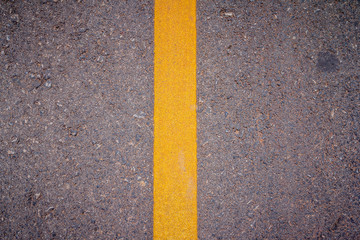 Asphalt road surface with yellow line