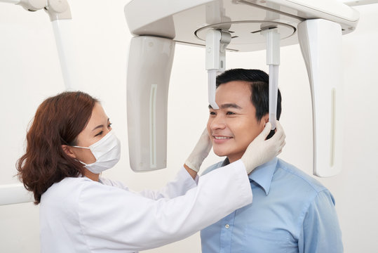 Man taking dental tac with cephalometric panorama x-ray machine in clinic