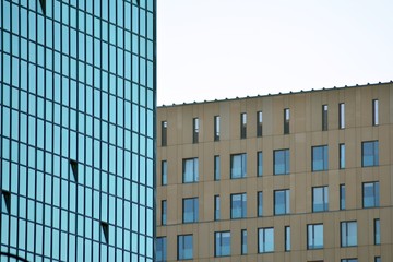Fototapeta premium Abstract fragment of contemporary architecture, walls made of glass and concrete. Glass curtain wall of modern office building