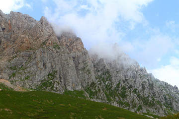 Fototapeta premium Top of the mountain in the clouds, high summit in the sky - photo of nature