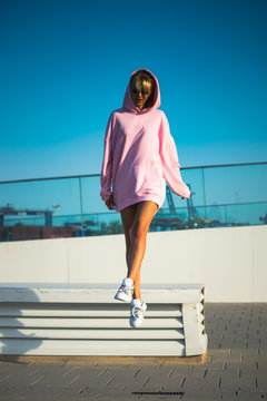 young woman jumping cheerful with urban clothes