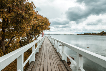 Wooden bridge along the shore of the Baltic Sea, in the capital of Finland, Helsinki, autumn...