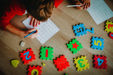 little boy and girl learn to write and calculate numbers