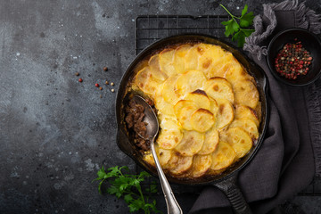 potato gratin with minced meat in cast iron pan
