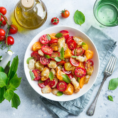 panzanella, traditional italian tomato and bread salad in white bowl