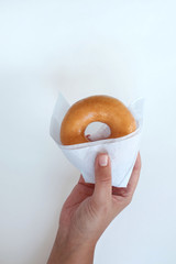 Original donut with in hand isolated on white