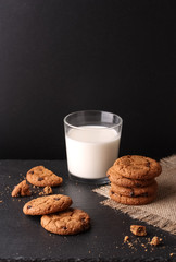 Tasty homemade cookies with a glass of milk. on the dark background.