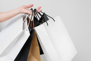 female hand with shopping bags on white background isolated