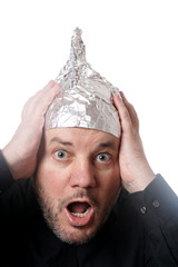 crazy scared man wearing tin foil hat, paranoia or conspiracy theory concept