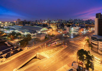 Fototapeta premium Aerial View of Bangkok Train Station or Hua Lamphong Railway Station in Blue Hour. Bangkok City with Car Traffic Light Trial at Twilight Time.