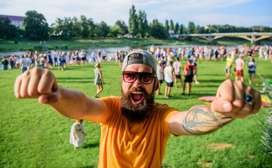 Man bearded hipster in front of crowd people raise fists green riverside background. Urban event...