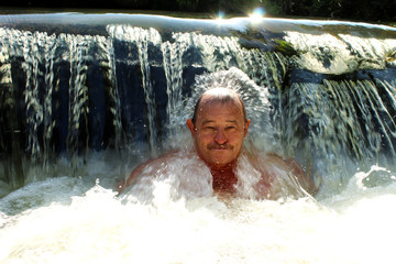 The elderly man in cold water. Hardening. Healthy lifestyle. 