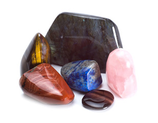 Different colored stones, jasper, lapis lazuli, labradorite, tiger's eye, rose quartz