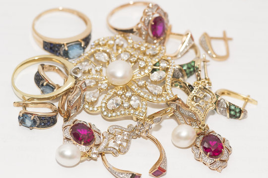 many gold ornaments with rubies, diamonds, pearls, emeralds