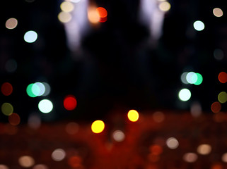 Abstract image of a defocused night city after a rain. Blurry background. Colorful abstract bokeh light on dark background.