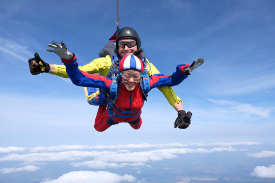 Skydiving. Tandem jump is with asian girl.