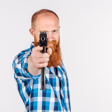 man with a rifle. human emotion expression and lifestyle concept. image on a white studio background.