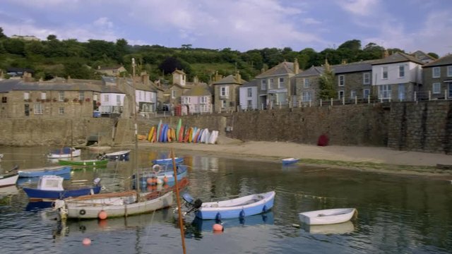 Pan across the pretty harbour of Mousehole in Cornwall 