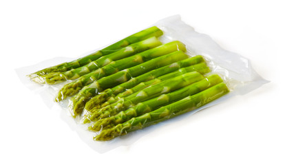 Asparagus vacuum sealed ready for sous vide cooking on white