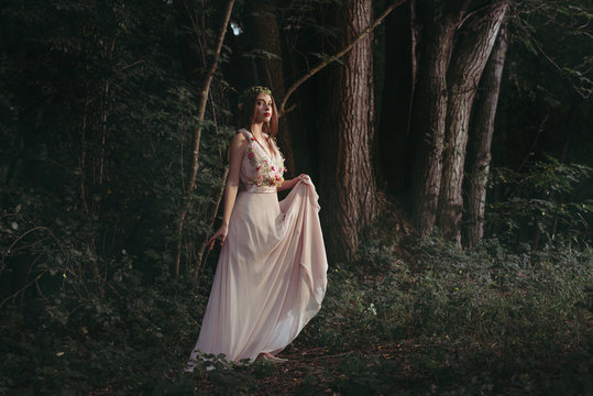 Attractive Mystic Elf In Elegant Flower Dress Walking In Woods