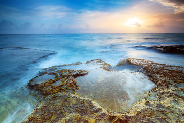 Beautiful sunrise at the rugged coast of the pacific in San Juan, Puerto Rico - obrazy, fototapety, plakaty