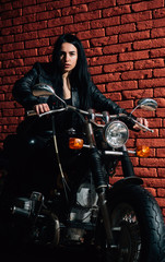Fototapeta na wymiar riding motorcycle. sexy woman riding motorcycle. woman biker riding motorcycle. girl riding motorcycle at brick wall.