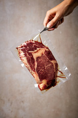 Beef steak vacuum sealed in tweezers