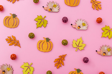 Multicolor wooden figures autumn elements like leafs, pumpkins, mushrooms, hedgehogs. Fall background.