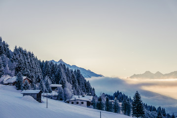 Fototapeta na wymiar Small hut in Alps mountains in winter scenery.