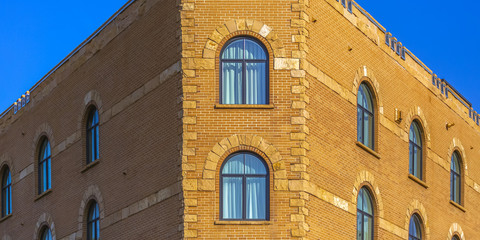 Blue sky behind corner building with mid day sun